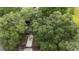 Birds eye view of the house, roof, driveway, and luscious trees at 3800 Ne 24Th Ct, Ocala, FL 34479