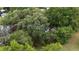 Birds eye view of the property with a small shed with a deck, and lush trees at 3800 Ne 24Th Ct, Ocala, FL 34479