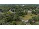 Aerial view of the neighborhood with many trees, green grass, and well maintained streets at 3800 Ne 24Th Ct, Ocala, FL 34479