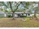View of the backyard of a single story home, surrounded by trees and a shed at 3800 Ne 24Th Ct, Ocala, FL 34479