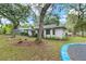 Home's backyard with a small cement patio, storage shed, mature trees, and a trampoline at 3800 Ne 24Th Ct, Ocala, FL 34479