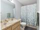 Bathroom featuring a single sink vanity with an elegant faucet and a shower with a floral patterned curtain at 3800 Ne 24Th Ct, Ocala, FL 34479