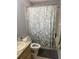 Bathroom features a tiled shower/tub combo with decorative curtain and updated fixtures for a modern feel at 3800 Ne 24Th Ct, Ocala, FL 34479