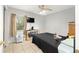 Bedroom with tiled floor, ceiling fan, and natural light from the window at 3800 Ne 24Th Ct, Ocala, FL 34479