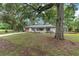 Charming house surrounded by mature trees, featuring a shed, and a tree house at 3800 Ne 24Th Ct, Ocala, FL 34479