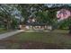 Single story home with front yard, a shed, and mature landscaping at 3800 Ne 24Th Ct, Ocala, FL 34479