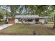 Charming single-story home featuring a cozy front yard and complementary yard shed at 3800 Ne 24Th Ct, Ocala, FL 34479