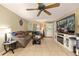 Bright living room featuring tile floors, ceiling fan, and comfortable seating at 3800 Ne 24Th Ct, Ocala, FL 34479