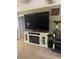 Cozy living room with an electric fireplace, large TV and decorative shelving at 3800 Ne 24Th Ct, Ocala, FL 34479