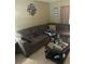 Comfortable living room featuring a large brown couch, tile floors, and decor at 3800 Ne 24Th Ct, Ocala, FL 34479