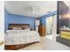 Bright and inviting main bedroom featuring a ceiling fan and a private ensuite bathroom at 3800 Ne 24Th Ct, Ocala, FL 34479