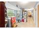 Mud room with utility sink, large windows, storage shelves, and ample space, next to the kitchen at 3800 Ne 24Th Ct, Ocala, FL 34479