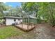 The yard has a utility shed, deck, riding lawn mower, and green lush grass at 3800 Ne 24Th Ct, Ocala, FL 34479