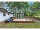View of the deck and shed, beside the house with freshly cut grass, and a lawn mower at 3800 Ne 24Th Ct, Ocala, FL 34479