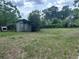Large backyard featuring a weathered shed, perfect for storage or outdoor projects at 3885 Ne 28Th Ter, Ocala, FL 34479