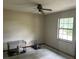 Spacious bedroom with a window and ceiling fan providing a comfortable atmosphere at 3885 Ne 28Th Ter, Ocala, FL 34479