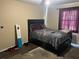 Bedroom featuring a bed, window, and incomplete flooring, ready for updates at 3885 Ne 28Th Ter, Ocala, FL 34479