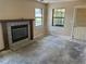 Cozy living room featuring a fireplace, windows and doorway, ready for renovation at 3885 Ne 28Th Ter, Ocala, FL 34479
