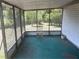 This is a screened patio with a chair and view of trees at 3885 Ne 28Th Ter, Ocala, FL 34479