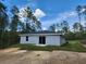 The backyard features a gray exterior with sliding glass doors, offering a private outdoor space at 404 Nw Redwing Rd, Dunnellon, FL 34431