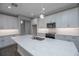 Modern kitchen features an island, stainless steel appliances, and sleek white cabinetry at 5830 Sw 121St Ter, Ocala, FL 34481