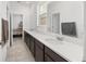 Modern bathroom with dual sinks, vanity, and a large mirror, offering ample counter space at 6486 Sw 75Th Avenue Rd, Ocala, FL 34474