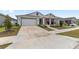 Inviting single-Gathering home with two-car garage, a quaint front porch, and well-maintained lawn at 6486 Sw 75Th Avenue Rd, Ocala, FL 34474