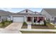 Charming single-Gathering home featuring a 2-car garage, a porch, and manicured landscaping at 6486 Sw 75Th Avenue Rd, Ocala, FL 34474