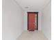 Covered front porch featuring a vibrant red door and neutral colors, creating a welcoming entrance at 6486 Sw 75Th Avenue Rd, Ocala, FL 34474