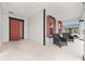 Cozy front porch with red door, red shutters, and black chairs, perfect for relaxing outdoors at 6486 Sw 75Th Avenue Rd, Ocala, FL 34474