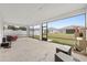 Enclosed lanai with concrete floor, outdoor furniture, and a view of the backyard and neighborhood at 6486 Sw 75Th Avenue Rd, Ocala, FL 34474