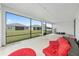 Enclosed lanai with concrete floor, outdoor furniture, and a view of the backyard and neighborhood at 6486 Sw 75Th Avenue Rd, Ocala, FL 34474