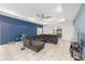 Spacious living room area with a comfortable sectional sofa, a sliding glass door, and tiled floor at 6486 Sw 75Th Avenue Rd, Ocala, FL 34474