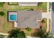 Aerial view showcasing a private screened-in pool, a well-maintained roof, and manicured landscaping at 6984 Sw 94Th Ct, Ocala, FL 34481