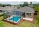 Aerial view highlighting the screened-in pool and landscaped backyard at 6984 Sw 94Th Ct, Ocala, FL 34481