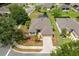 Aerial view of the home showcasing its well-manicured lawn, two-car garage, and position on a corner lot at 6984 Sw 94Th Ct, Ocala, FL 34481
