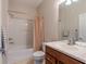 Bathroom featuring a shower-tub combo with a curtain, a toilet, and a wood vanity with a sink at 6984 Sw 94Th Ct, Ocala, FL 34481