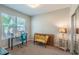 Bedroom with a large window, a vanity, a desk, a chair, a loveseat, and an ornate side table at 6984 Sw 94Th Ct, Ocala, FL 34481