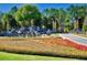 Stone Creek entrance with rock waterfall and landscaped flower beds at 6984 Sw 94Th Ct, Ocala, FL 34481