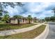 Charming single-story home with a well-manicured lawn, mature palm trees, and a paved driveway at 6984 Sw 94Th Ct, Ocala, FL 34481