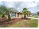 Beautiful home with a manicured lawn, complemented by vibrant plants and an inviting walkway at 6984 Sw 94Th Ct, Ocala, FL 34481