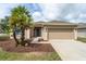 Charming home with lush landscaping, featuring a well-maintained lawn and a two-car garage at 6984 Sw 94Th Ct, Ocala, FL 34481