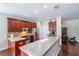 Kitchen with stainless steel appliances, dark cabinets, a breakfast bar and dark hardwood floors at 6984 Sw 94Th Ct, Ocala, FL 34481