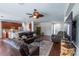 Open concept living room featuring hardwood floors, ceiling fans, a view of the kitchen and a front entryway at 6984 Sw 94Th Ct, Ocala, FL 34481