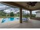 Relaxing screened-in patio with stylish lounge chairs overlooking a pristine private pool, ideal for outdoor enjoyment at 6984 Sw 94Th Ct, Ocala, FL 34481