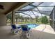 Inviting screened-in pool area with lounge chairs and a relaxing atmosphere at 6984 Sw 94Th Ct, Ocala, FL 34481
