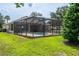 Sparkling screened-in pool with lounge chairs, set in a well-maintained backyard at 6984 Sw 94Th Ct, Ocala, FL 34481