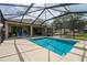 A private screened-in pool area with lounge chairs and views of the backyard and the house at 6984 Sw 94Th Ct, Ocala, FL 34481