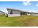 Expansive backyard with lush green lawn and a covered patio perfect for outdoor entertaining at 7638 Sw 60Th St, Ocala, FL 34474
