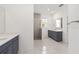Modern bathroom with marble-look floors, dual vanity, and tiled shower at 7638 Sw 60Th St, Ocala, FL 34474